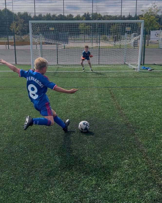 Young players enjoying football together at AC Coaching