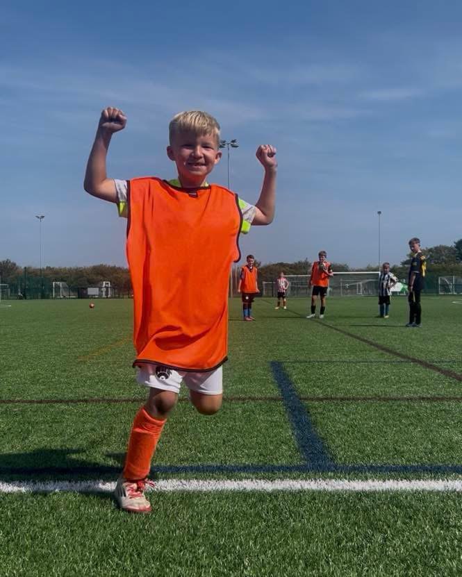 Footballer shooting towards goal