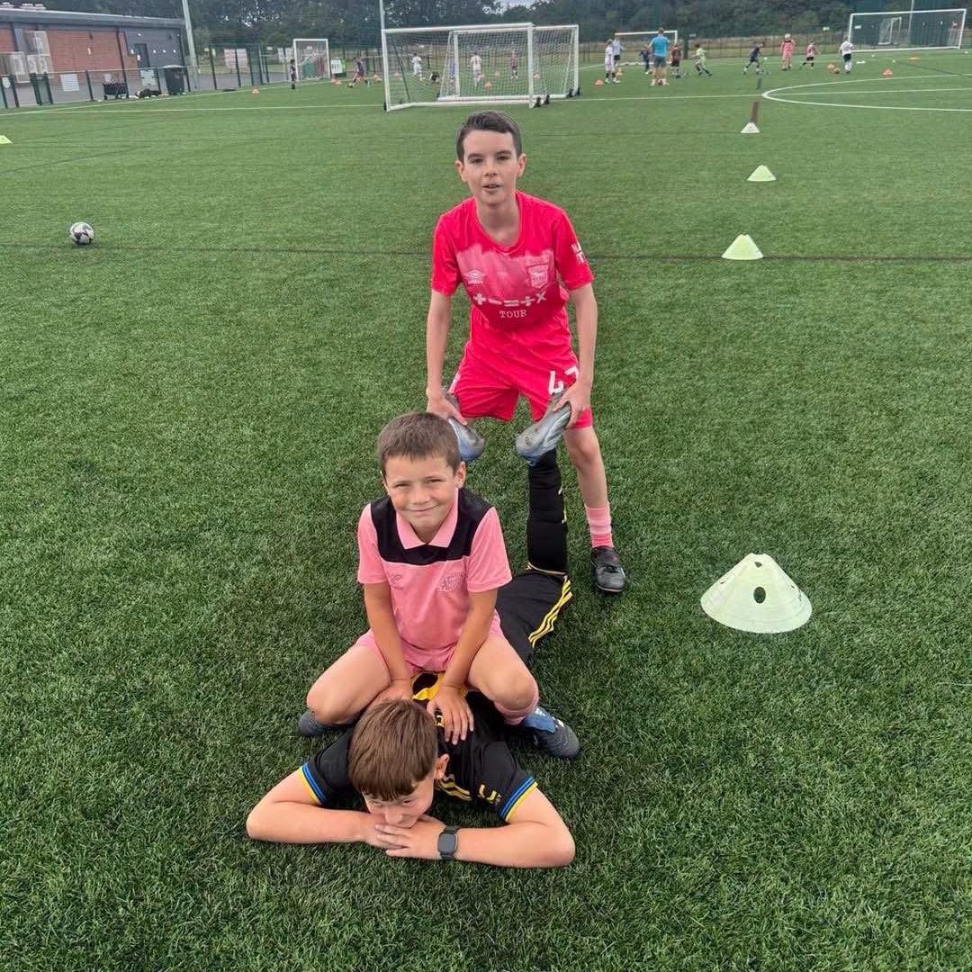 Young footballer smiling at camp